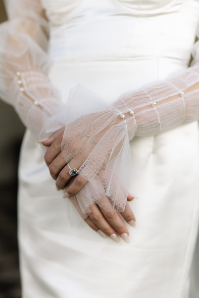 robe de mariée, mains de la mariée, bague de fiançailles, perles, tulle, manucure